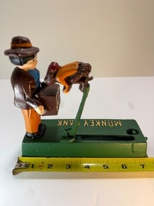 lot 82 image: Vintage Cast Iron Mechanical Monkey Bank Coin Bank