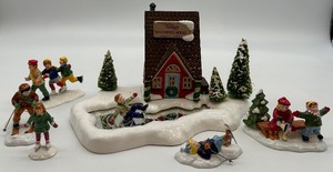lot 9 image: Department 56 Snow Village Warming House with Skaters and Skiers Handpainted Ceramic Set