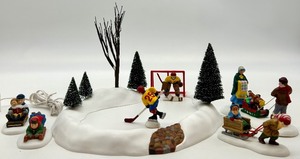 lot 72 image: Department 56 Village Animated Hockey Player and Sledding Figurines Set