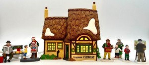 lot 110 image: Department 56 Frogmore Chemist Illuminated Village Building with 7 Holiday Figures