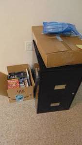 lot 54 image: File Cabinet, DVDs and VCR Player