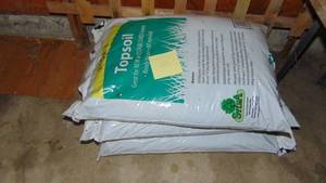 lot 154 image: 3- Bags of Top Soil and Wood Gate