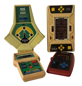 lot 23 image: Set of 4 Vintage Handheld Electronic Games including Armor Battle, Electronic Quarterback, Head to Head Baseball and Hockey