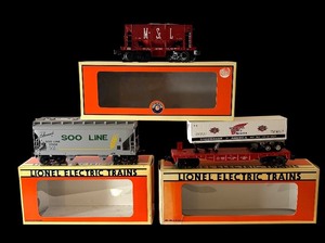 lot 84 image: Lionel Electric Train Cars Set with Boxes - Red Wing Shoes Flat Car, SOO Line Hopper and M&STL Ore Car