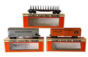 lot 99 image: Lionel O Gauge Train Cars including Norfolk & Western Hopper, New York Central Flat Car with Stakes and Illinois Central Box Car