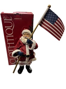 lot 91 image: Clothique Santa Figurine Holding American Flag with Original Box