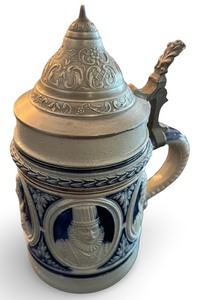 lot 58 image: German Stoneware Beer Stein with Pewter Lid and Ornate Relief Design