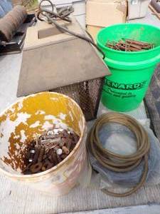lot 124 image: Green Menards Box with nails, Bug Zapper, Hose, Bucket of Bolts