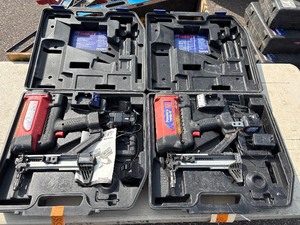lot 158 image: 2 Powers Trak-It Gas Fastening tool in cases battery in one case has a charge. Both fasteners power up