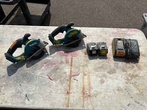 lot 173 image: (2) Makita XSC01 handheld circular saws with (1) 18V 3.0 AH  and (1) 4.0 AH batteries & a DC18RA charger