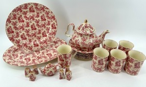 lot 102 image: Red Toile Pattern Porcelain Tea Set with Teapot, Cups, Plates and Accessories