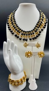 lot 211 image: Vintage Jewelry Set - Black and Gold Bead Necklace, Monet Gold-Tone Bracelet, and Rhinestone Clip Earrings