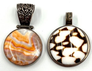 lot 253 image: Pair of Sterling Silver Pendants with Coral Agate and Reversible Shell and Floral Cutout & Spiderweb Pattern