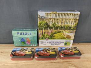 lot 207 image: 3 Jigsaw Puzzles Palace of the Parliament, Jesus Give Me Your Hand, Disney Cars Tins - Brand New