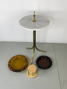 lot 99 image: Small marble-top end table with vintage ashtrays and coasters