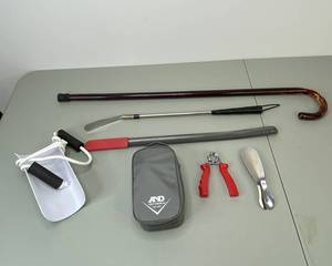 lot 361 image: Golden Years Kit with Blood Pressure Monitor, Cane, Shoe Horns, and Sock Assist