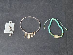 lot 98 image: Trio of Jewelry Surgical Steel Key Navel Ring, Charm Bangle, Turtle Beaded Bracelet