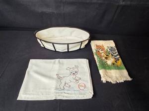 lot 103 image: Decorative Basket with Liner, Kitten Towel, and Embroidered Puppy Towel Set