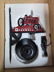 lot 195 image: McCormick Farmall Tractor Cast Iron Bell Set