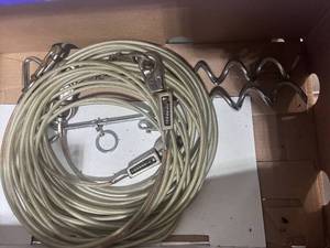 lot 63 image: Two Dog Tie Out Screws and Two Tie Out Cables