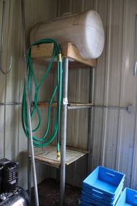 lot 8 image: Poly Storage Tank with Steel Stand and Hose