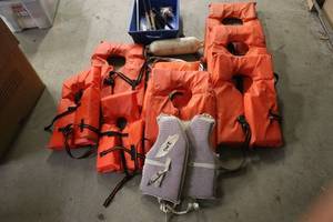 lot 55 image: Lot of 6 Orange Life Jackets, 1 Adjustable Life Vest, and Fishing Accessories