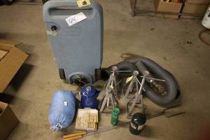 lot 64 image: Garage and Camping Utility Lot with Jack Stands, Blue Jug, Sleeping Bag, and Tools
