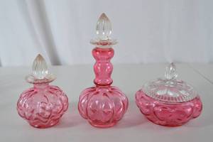 lot 49 image: Vintage Fenton Pink Glass Vanity Set with Stoppers and Lidded Jar