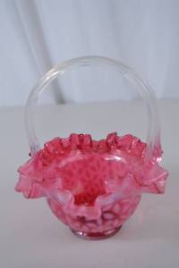 lot 81 image: Pink Fenton opalescent glass basket with clear handle, ruffled rim, floral pattern