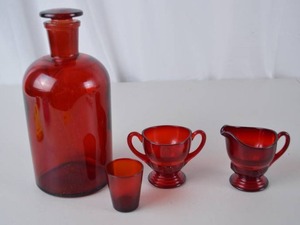 lot 184 image: Ruby Red Glassware Lot - Decanter, Creamer, Sugar Bowl, Shot Glass (4 Pc)