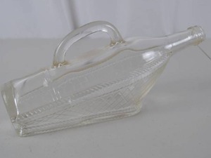 lot 205 image: Vintage Clear Glass Ship-Shaped Bottle with Handle