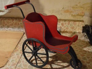 lot 298 image: Vintage Red Painted Wooden Doll Carriage with Cast Iron Wheels