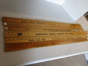 lot 25 image: Wooden advertising yardsticks, one ...