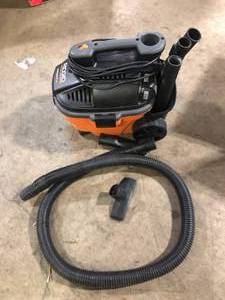 lot 24 image: RIDGID 4 Gal. 5.0 Peak HP Portable Shop Vacuum Wet Dry Vac with Fine Dust Filter, Locking Hose and Attachments WD4070Used Good  Customer Returns See Pictures