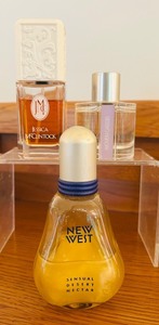 lot 133 image: K - Lot of 6 Designer Perfume and Eau de Toilette Bottles - Lalique, Escada, Jessica McClintock, New West, Woven Cassis, Sensual Skinscent