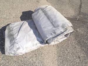 lot 105 image: Large Tarp Gray Good For Woodpile may have holes or rips