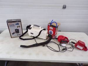 lot 57 image: Coleman road trip heater,  Oreck Vacuum, and Air Pumps