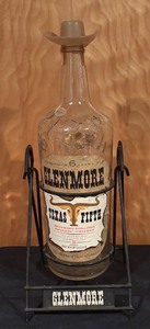 lot 164 image: Vintage Glenmore Texas Fifth Bottle with Metal Stand and Cowboy Hat Topper