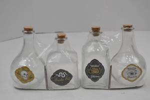 lot 92 image: Set of 4 Halloween Potion Glass Bottles with Corks and Labels
