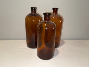 lot 4 image: Set of 3 Vintage Amber Glass Bottles
