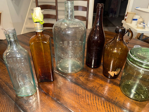 lot 172 image: Collection of Vintage Glass Bottles with Embossed Text