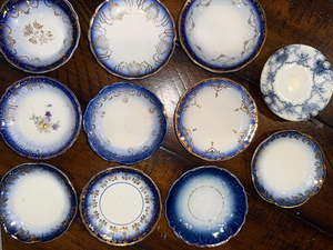 lot 89 image: Antique French Flow Blue Butter Pat Plates Set of 11 with Gold Detailing