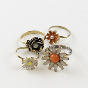 lot 102 image: Group of 4 Vintage Base Metal Floral Rings Size 5-8