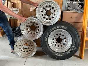 lot 25 image: 4 - 15 Alum Rims, 1 with Wild Country Radial XRT 23575R15