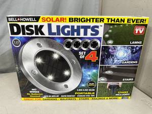 lot 85 image: New 4 Pack of Solar Garden Disk Lights