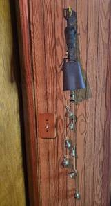 lot 40 image: Vintage Large Cowbell and Hanging String of Bells with Leather Strap