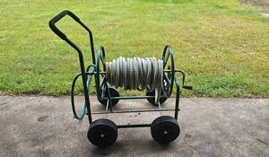 lot 88 image: Mobile Garden Hose Reel Cart with Hose and Wheels