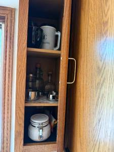 lot 177 image: Kitchenware Set with Mugs, Glass Bottles, Measuring Cups, and Ceramic Storage Jar