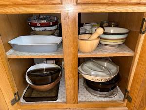 lot 181 image: Large Kitchenware Collection with Mixing Bowls, Mugs, Bakeware, and KitchenAid Attachments
