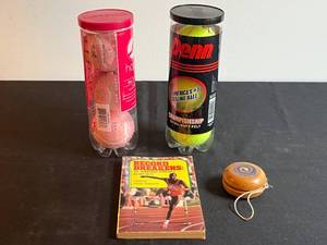 lot 203 image: Sports Memorabilia Collection with Book, Wooden Yo-Yo, and Tennis Ball Cans